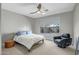 Spacious bedroom with a large window, plush bedding, and a comfortable chair at 1873 W Dion Dr, Anthem, AZ 85086