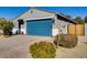 House exterior showcasing a blue garage door and neatly landscaped yard at 22432 W Kimberly Dr, Buckeye, AZ 85326