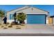 Single-story home with a blue garage door and landscaped front yard at 22432 W Kimberly Dr, Buckeye, AZ 85326