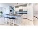 Granite kitchen island with seating and stainless steel appliances at 22432 W Kimberly Dr, Buckeye, AZ 85326