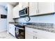 Modern kitchen with granite countertops and white cabinets at 22432 W Kimberly Dr, Buckeye, AZ 85326