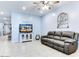 Spacious living room featuring comfortable seating and a large TV at 22432 W Kimberly Dr, Buckeye, AZ 85326