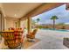 Covered patio with seating area overlooking a refreshing pool and mountain views at 32159 N 127Th Dr, Peoria, AZ 85383
