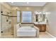 Spa-like bathroom with soaking tub, walk-in shower, and updated fixtures at 32159 N 127Th Dr, Peoria, AZ 85383