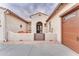 Front entry with a brown door and two orange chairs at 32159 N 127Th Dr, Peoria, AZ 85383