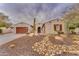 One-story house with drought-tolerant landscaping and a three-car garage at 32159 N 127Th Dr, Peoria, AZ 85383