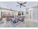 Open concept living room with large sectional sofa and views of the kitchen at 32159 N 127Th Dr, Peoria, AZ 85383