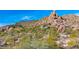 Luxury home nestled on rocky hillside, surrounded by cacti at 35035 N Whileaway Rd, Carefree, AZ 85377