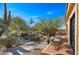 Landscaped backyard with desert plants and patio seating at 35035 N Whileaway Rd, Carefree, AZ 85377
