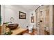 Rustic bathroom with a copper sink and walk-in shower at 35035 N Whileaway Rd, Carefree, AZ 85377