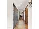 Long hallway with terracotta tile floors, arched doorways, and a patterned rug at 35035 N Whileaway Rd, Carefree, AZ 85377
