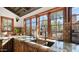 Rustic kitchen with granite counters, wood cabinets, and a large island at 35035 N Whileaway Rd, Carefree, AZ 85377