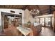 Island kitchen with breakfast bar, exposed beams, and views into living room at 35035 N Whileaway Rd, Carefree, AZ 85377