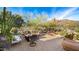 Spacious patio with fire pit, seating area, and mountain views at 35035 N Whileaway Rd, Carefree, AZ 85377