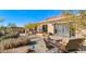 Stone patio with seating area and desert landscaping at 35035 N Whileaway Rd, Carefree, AZ 85377