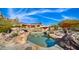 Inviting pool surrounded by desert landscaping and large boulders at 35035 N Whileaway Rd, Carefree, AZ 85377