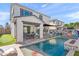 Resort-style backyard with a sparkling pool, patio furniture, and mural at 3750 E Earll Dr, Phoenix, AZ 85018