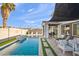 Relaxing backyard with a refreshing pool, patio furniture, and lush landscaping at 3750 E Earll Dr, Phoenix, AZ 85018