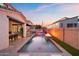 Evening view of a luxurious backyard pool and patio area with fire pit at 3750 E Earll Dr, Phoenix, AZ 85018