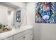 Clean bathroom with white cabinets and a large mirror at 3750 E Earll Dr, Phoenix, AZ 85018