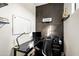 Modern home office with a glass desk and built-in shelving at 3750 E Earll Dr, Phoenix, AZ 85018