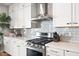 Modern kitchen with white cabinets, stainless steel appliances, and white countertops at 3750 E Earll Dr, Phoenix, AZ 85018