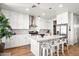 Modern kitchen with white cabinets, center island, and stainless steel appliances at 3750 E Earll Dr, Phoenix, AZ 85018