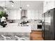 Modern kitchen with white cabinets, a large island, and stainless steel appliances at 3750 E Earll Dr, Phoenix, AZ 85018
