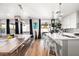 Modern kitchen with white cabinets, large island, and stainless steel appliances at 3750 E Earll Dr, Phoenix, AZ 85018