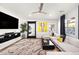 Spacious living room with L-shaped sofa, large TV, and modern decor at 3750 E Earll Dr, Phoenix, AZ 85018