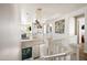 Upstairs hallway with white railings, modern light fixtures, and artwork at 3750 E Earll Dr, Phoenix, AZ 85018