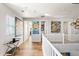 Light-filled upper hallway showcasing artwork and white railing at 3750 E Earll Dr, Phoenix, AZ 85018