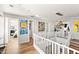 Bright hallway with hardwood floors and modern art at 3750 E Earll Dr, Phoenix, AZ 85018