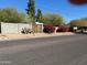 Residential home with gated entry and red flowers at 5702 N 10Th Pl, Phoenix, AZ 85014