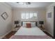 Bedroom with a gray bed frame and a window with shutters at 8502 E Catalina Dr, Scottsdale, AZ 85251