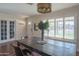 Spacious dining area with large windows and a farmhouse table at 8502 E Catalina Dr, Scottsdale, AZ 85251