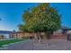 Brick ranch home with a large tree and well maintained lawn at 8502 E Catalina Dr, Scottsdale, AZ 85251