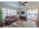 Bright living room with comfy seating, wood floors, and sliding glass doors leading to a patio at 8502 E Catalina Dr, Scottsdale, AZ 85251