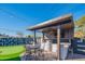 Modern outdoor kitchen with built-in grill and ample seating at 8502 E Catalina Dr, Scottsdale, AZ 85251