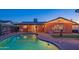 Stunning kidney-shaped pool at night with lights at 8502 E Catalina Dr, Scottsdale, AZ 85251