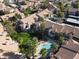 Aerial view of a condo complex with pool, lush landscaping, and residential buildings at 930 N Mesa Dr # 2073, Mesa, AZ 85201