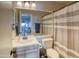 Bright bathroom features a large mirror, updated vanity, and shower with a neutral-striped curtain at 930 N Mesa Dr # 2073, Mesa, AZ 85201