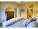 Comfortable bedroom with a cozy bed, wooden dresser, and ensuite bathroom at 930 N Mesa Dr # 2073, Mesa, AZ 85201