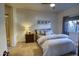 Relaxing bedroom featuring natural light, carpet floors, and a cozy bed with striped bedding at 930 N Mesa Dr # 2073, Mesa, AZ 85201