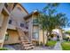Building exterior view of a two-story condo featuring an outdoor stairway and landscaping at 930 N Mesa Dr # 2073, Mesa, AZ 85201