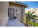 Condo entrance features a cozy front porch with a welcome mat and exterior lighting at 930 N Mesa Dr # 2073, Mesa, AZ 85201