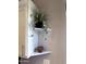 White corner shelf with decorative plants and candle at 930 N Mesa Dr # 2073, Mesa, AZ 85201
