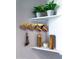 White corner shelves with copper mugs and wooden pepper mills at 930 N Mesa Dr # 2073, Mesa, AZ 85201