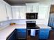 Modern kitchen with stainless steel appliances and blue cabinets at 930 N Mesa Dr # 2073, Mesa, AZ 85201