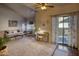 Bright living room featuring high ceilings, a modern couch, and a sliding glass door with natural light at 930 N Mesa Dr # 2073, Mesa, AZ 85201
